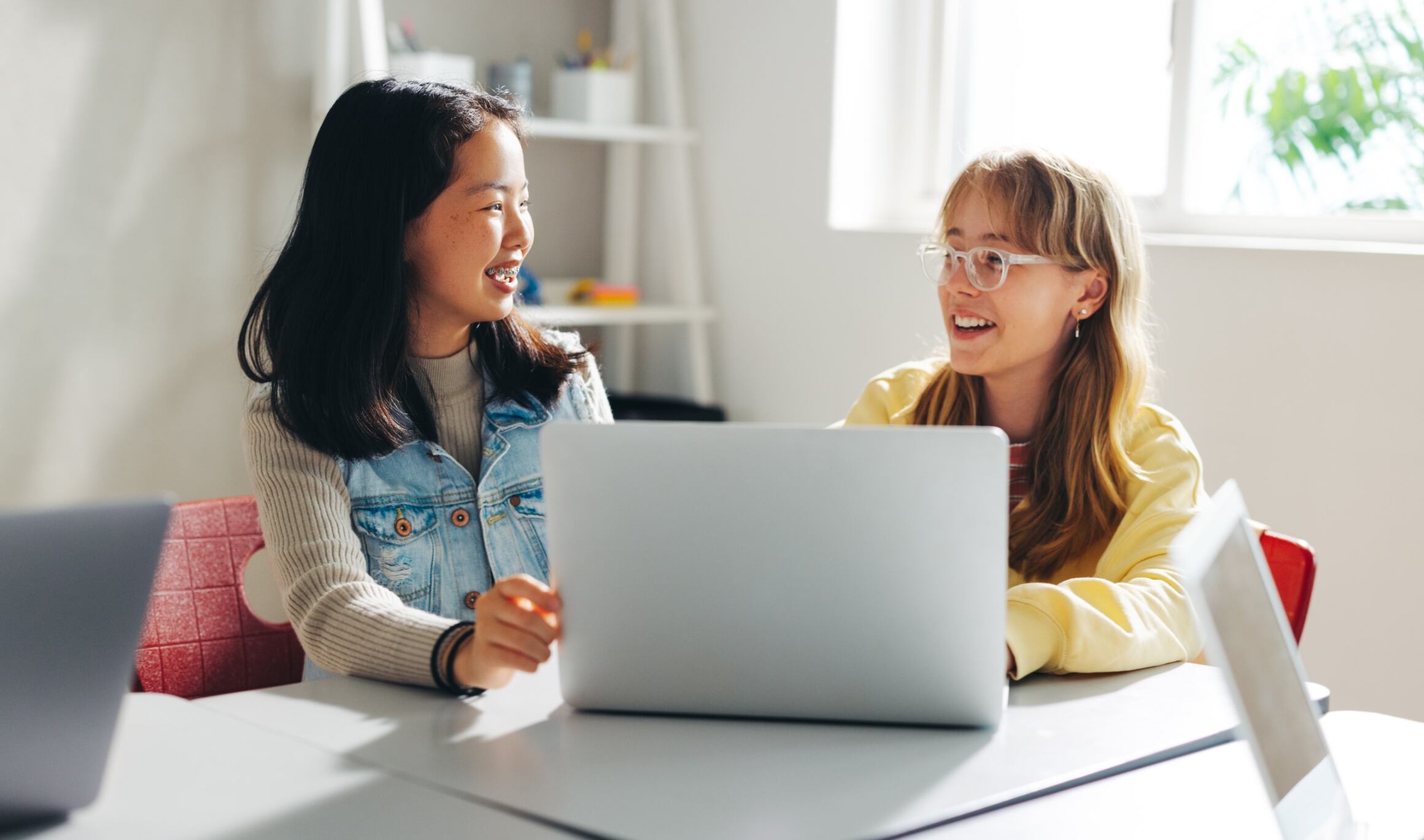 Girls chatting with each other during an advanced programming class with Berlitz Digital School.