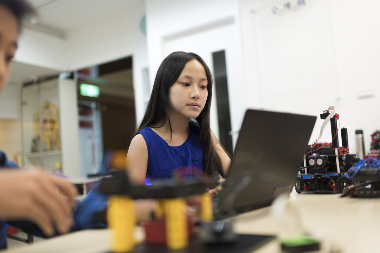 Girl learning programming using a laptop during a Summer School with Berlitz Digital School.