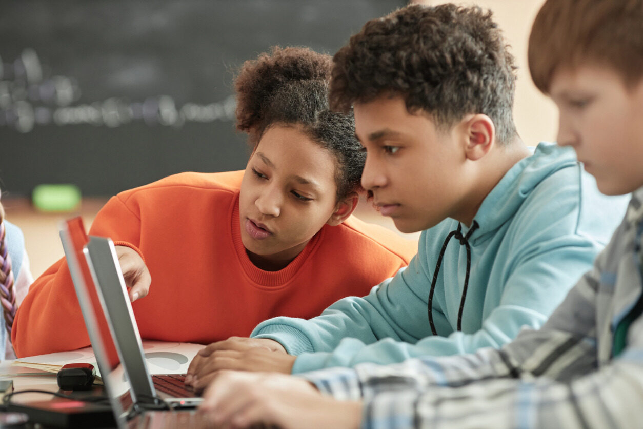 Children in front of a laptop learning app development for kids with Berlitz Digital School.