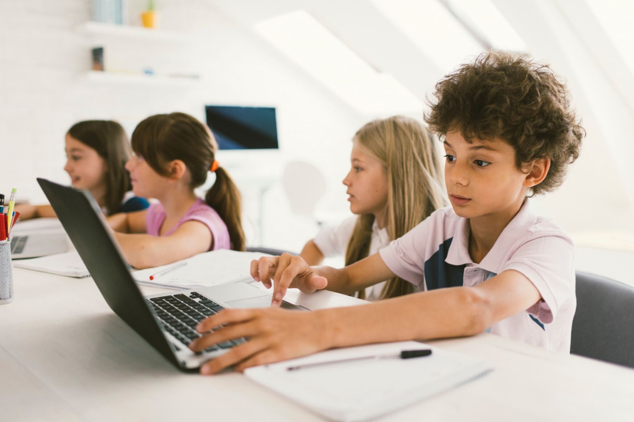 Kid typing on his computer during a programming class with Berlitz Digital School.