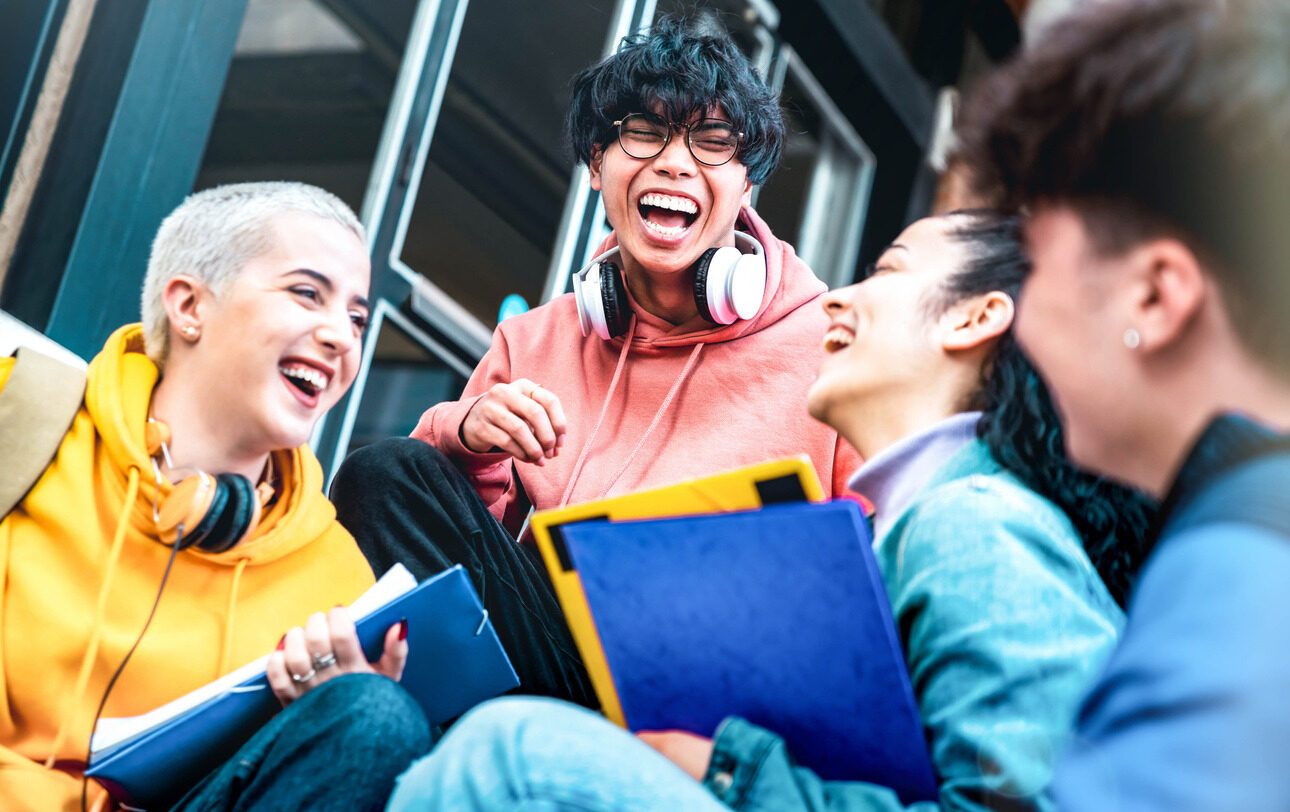 Students chatting and laughing after their application development class for kids and teens with Berlitz Digital School.