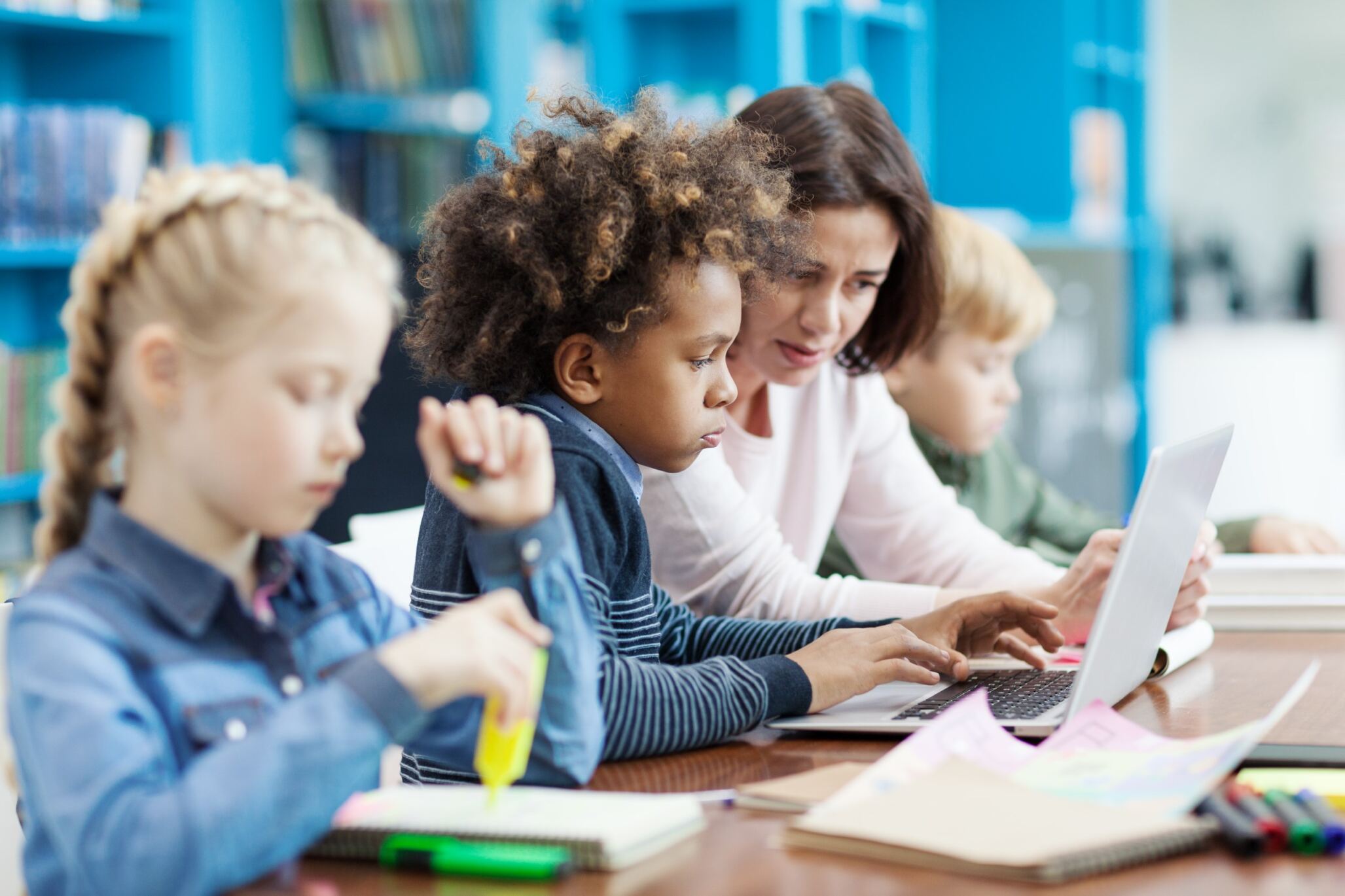 Instructor talking to students during their coding class for kids.